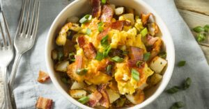 Bowl of Homemade Scrambled Eggs with Bacon and Green Onions