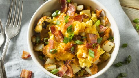 Bowl of Homemade Scrambled Eggs with Bacon and Green Onions