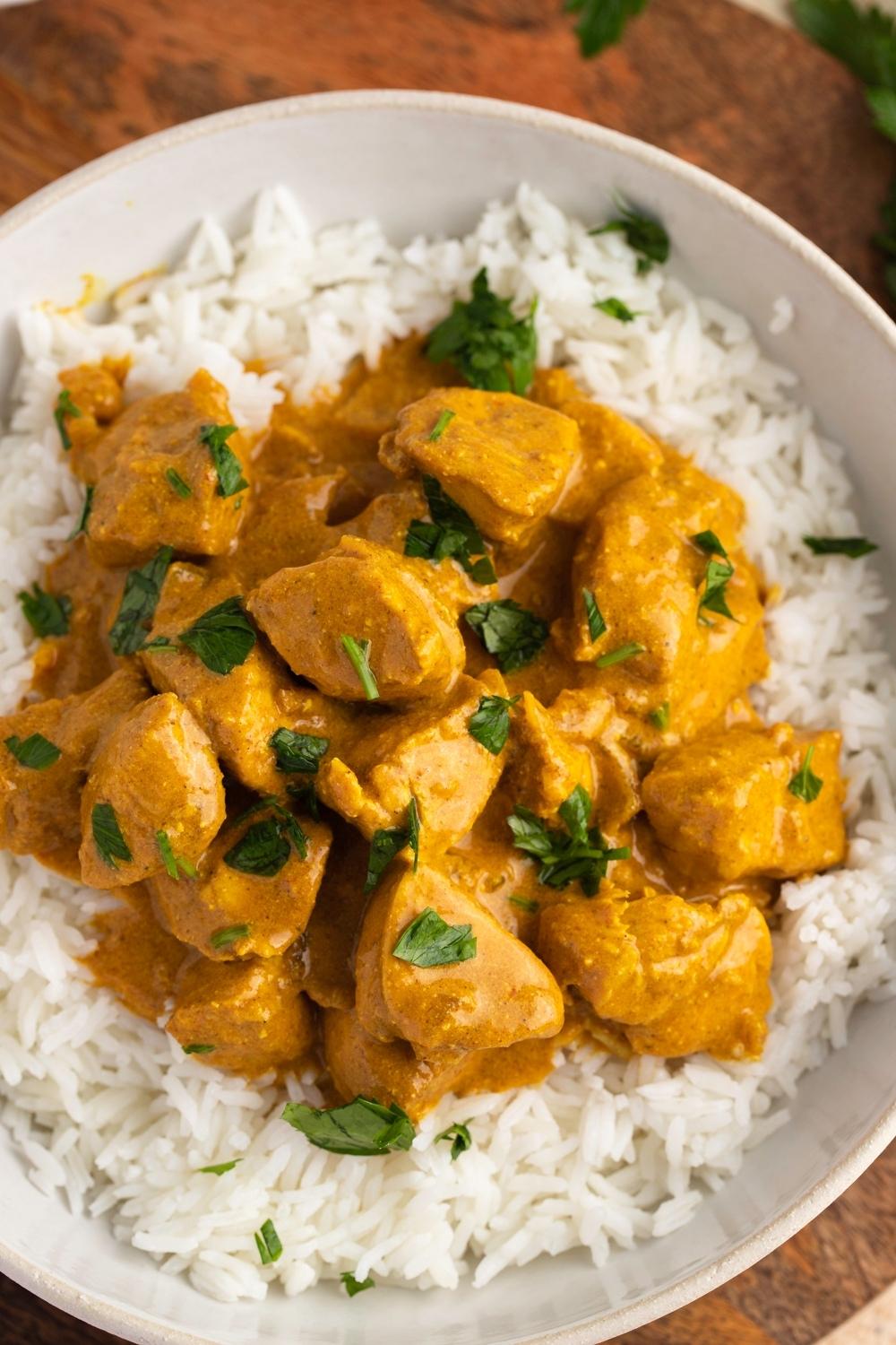 Bowl of Indian Chicken Curry with Herbs and Rice