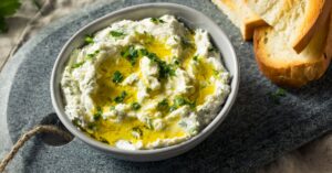 Bowl of Vegan Goat Cheese Dip with Toasted Bread