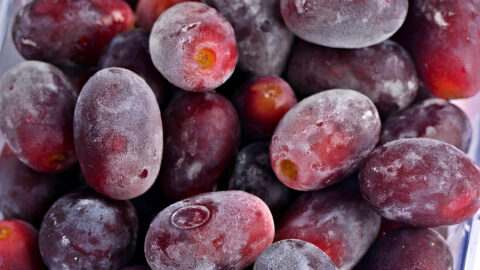 Frozen Grapes on a Plastic Container