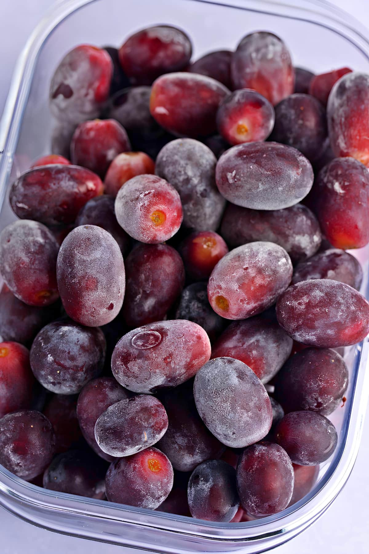 Frozen Grapes on a Plastic Container