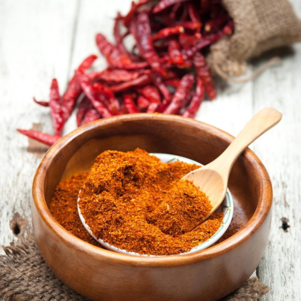 Ground Cayenne Pepper in a Wooden Bowl