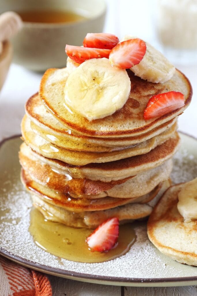 Homemade Banana Flour Pancakes with Banana Slices and Strawberries