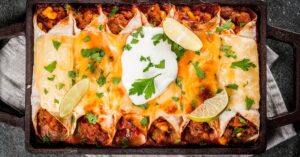 Homemade Beef Enchiladas with Whipped Cream and Lime