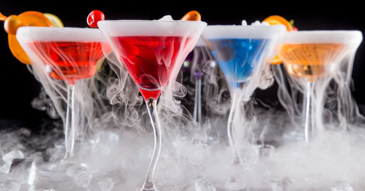 https://insanelygoodrecipes.com/wp-content/uploads/2022/07/Homemade-Boozy-Multi-Colored-Dry-Ice-Cocktails-with-Fruits.jpg