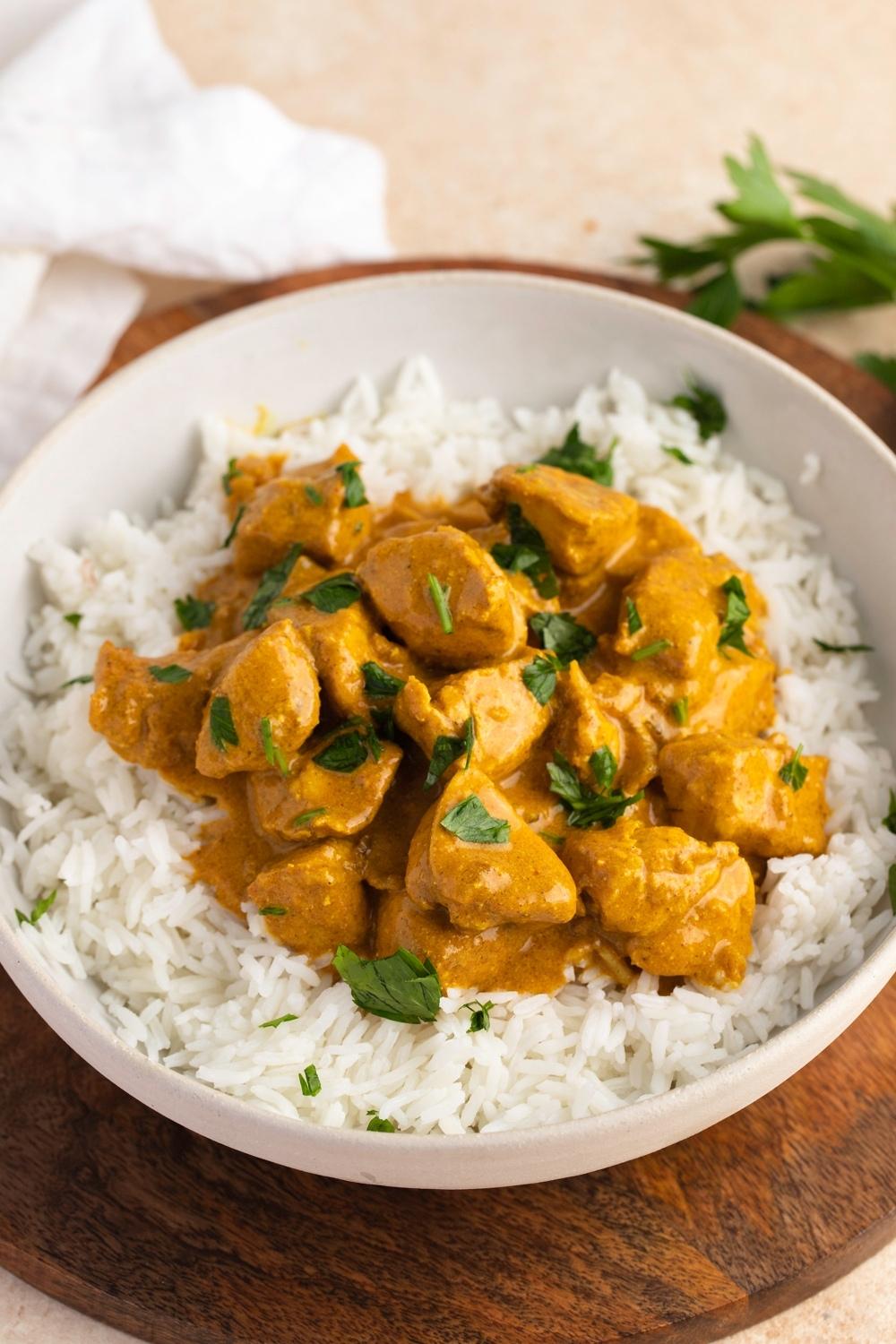 Homemade Indian Chicken Curry with Herbs and Rice in a Bowl