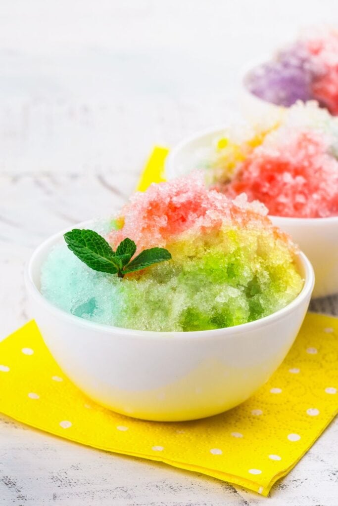 15 Shaved Ice Recipes. Shown in picture: Homemade Rainbow Shaved Ice in a White Bowl