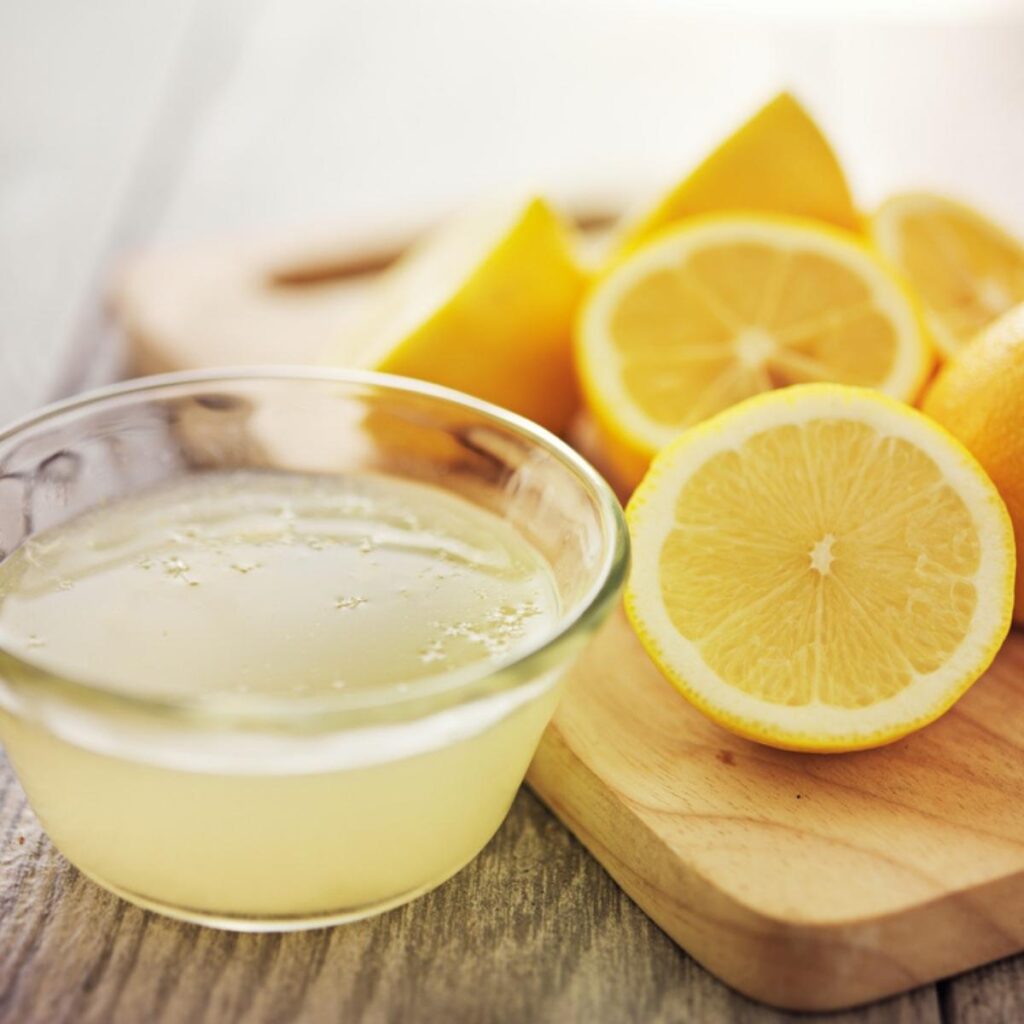 Sliced Lemon and Lemon Juice in a Glass Dish
