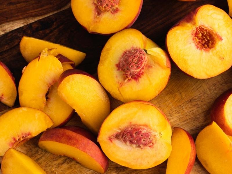 How to Freeze Peaches: peaches sliced in half
