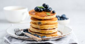 Stacked Pancakes with Blueberries and Honey