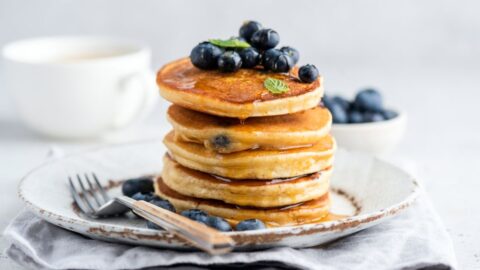 Stacked Pancakes with Blueberries and Honey