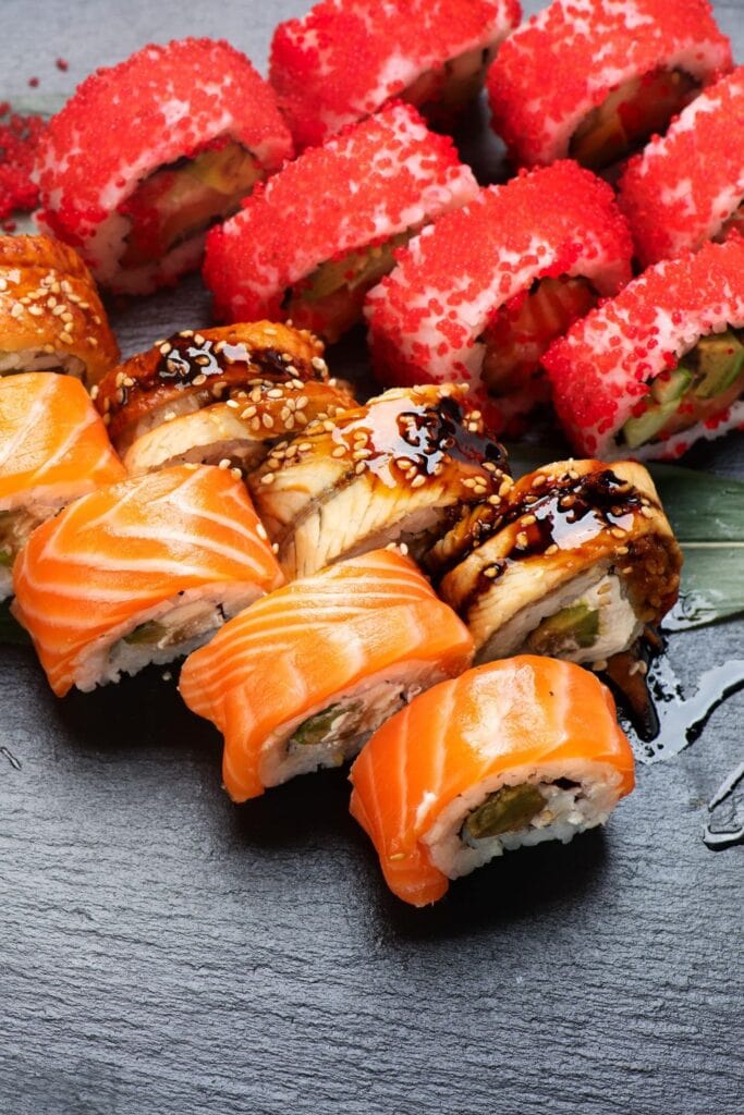 15 Easy Sushi Recipes Everyone Will Love. Sushi rolls with vegetables and salmon shown in picture.