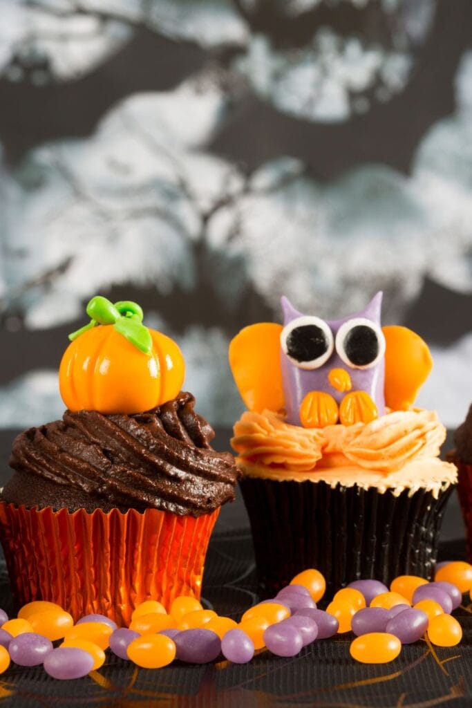 30 Halloween Potluck Recipes for a Killer Party! Shown in picture: Sweet Halloween Cupcakes with Pumpkin and Owl Design