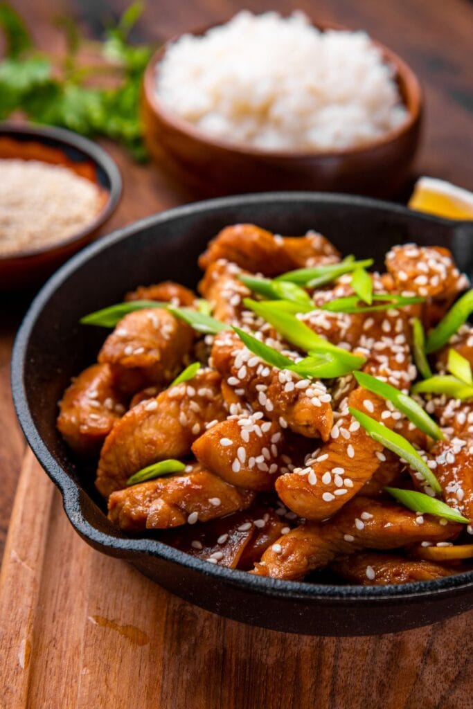 30 Gluten-Free Chicken Recipes Everyone Will Love: Teriyaki Chicken In Frying Pan with Green Onions and Sesame Seeds