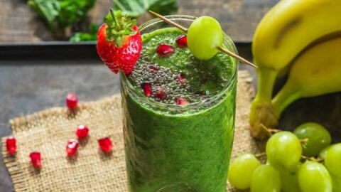 A Glass of Healthy Kale and Grape Smoothie with Fresh Strawberry