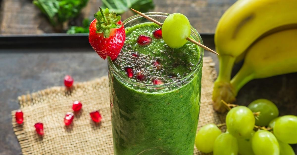 A Glass of Healthy Kale and Grape Smoothie with Fresh Strawberry
