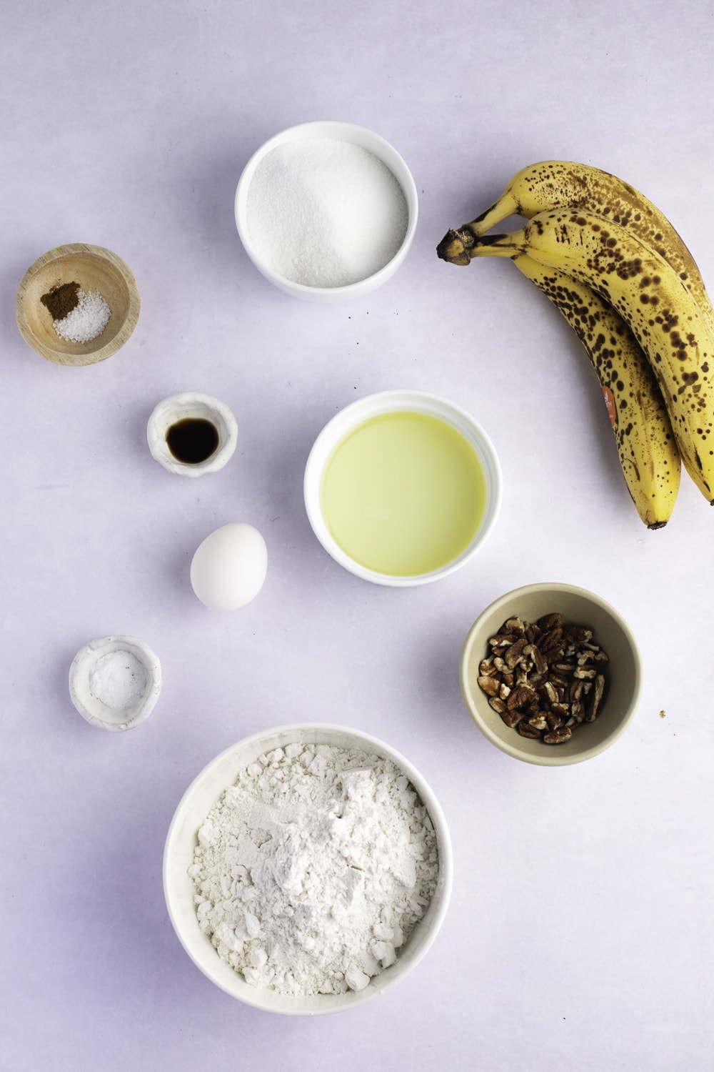 Banana Bread Muffin Ingredients - Sugar, Oil, Egg, Vanilla, Bananas, Walnuts, Flour, Baking Soda, Salt and Cinnamon