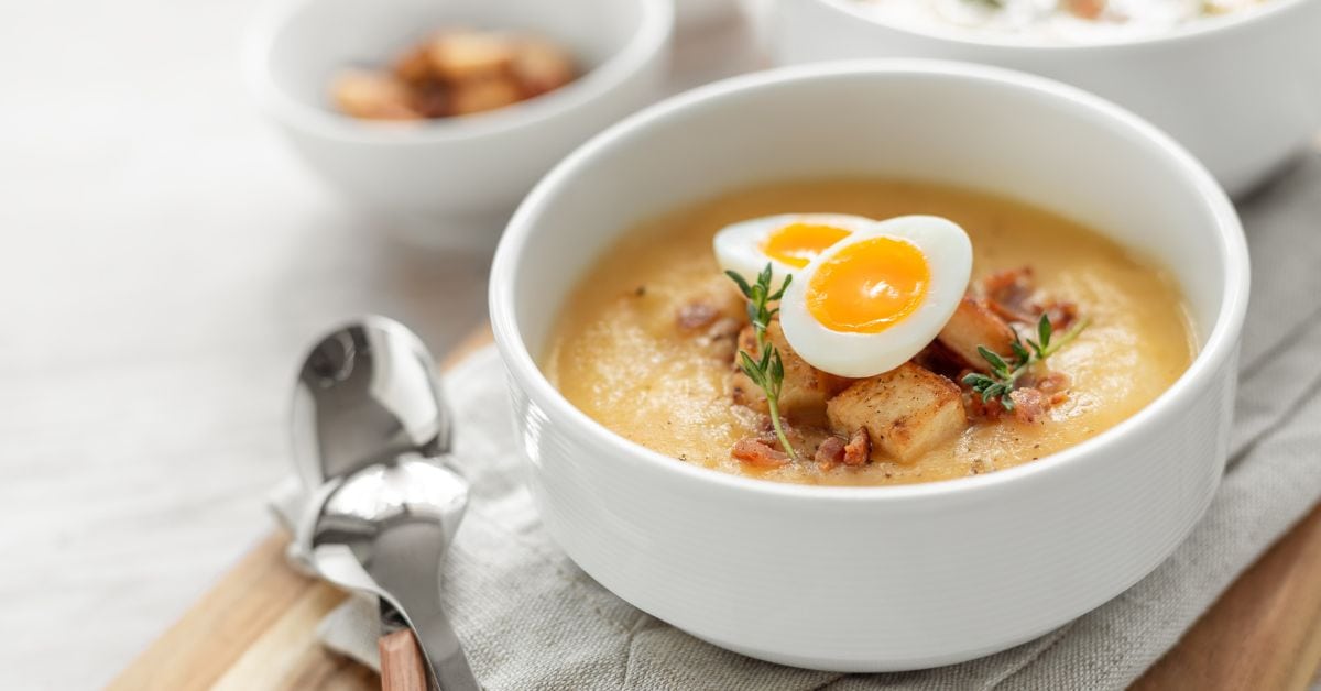 Bowl of Creamy Bacon Soup with Celery Root and Egg