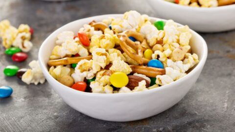 Bowl of Snack Mix with Chocolate Candies, Pretzels and Popcorn