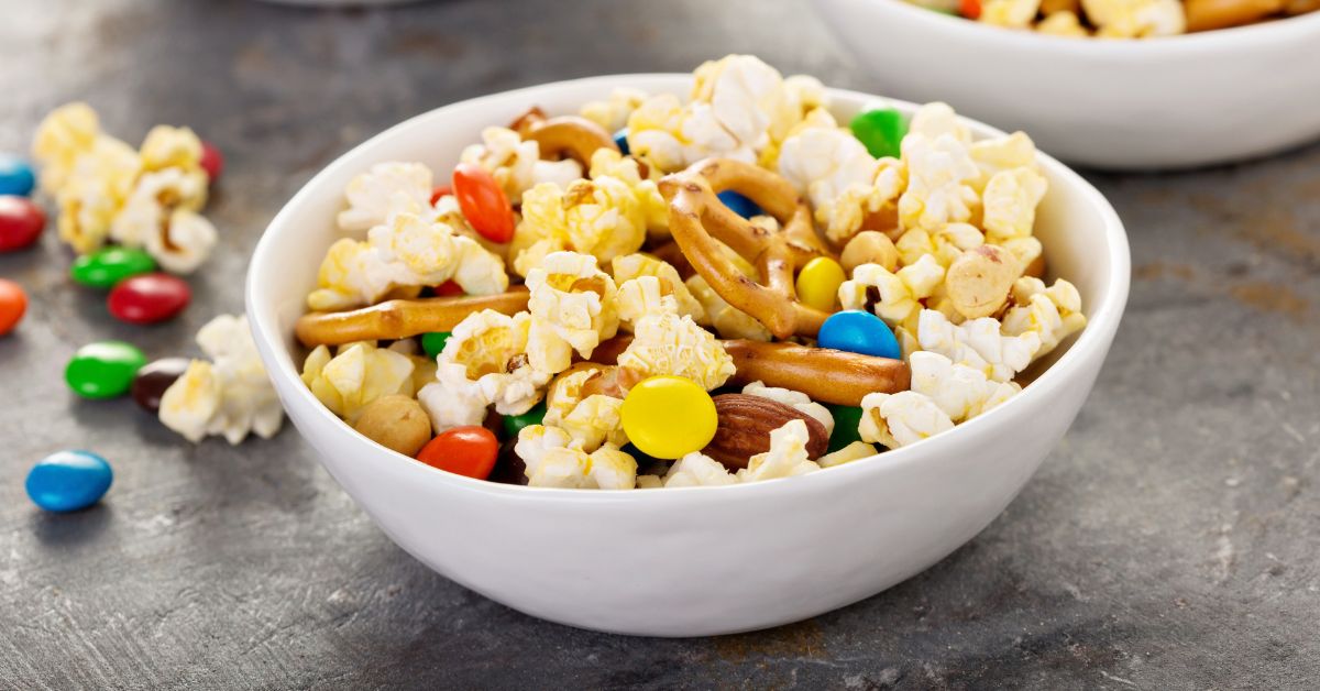 Bowl of Snack Mix with Chocolate Candies, Pretzels and Popcorn