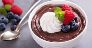 Bowl of Sweet Chocolate Pudding with Oat Milk, Whipped Cream and Berries