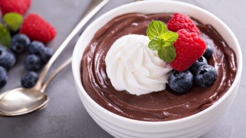Bowl of Sweet Chocolate Pudding with Oat Milk, Whipped Cream and Berries