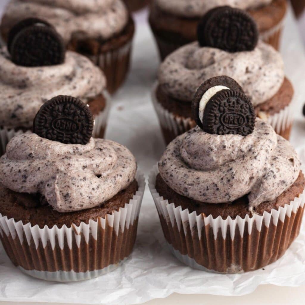 Chocolate Cupcakes Topped With Flavored Whipped Cream and Oreo Minis
