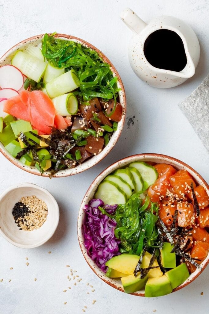 20 Healthy Poke Bowls (+Easy Recipes): Hawaiian Poke Bowls: Tuna and Salmon with Avocados, Cucumber Red Cabbage and Seaweeds