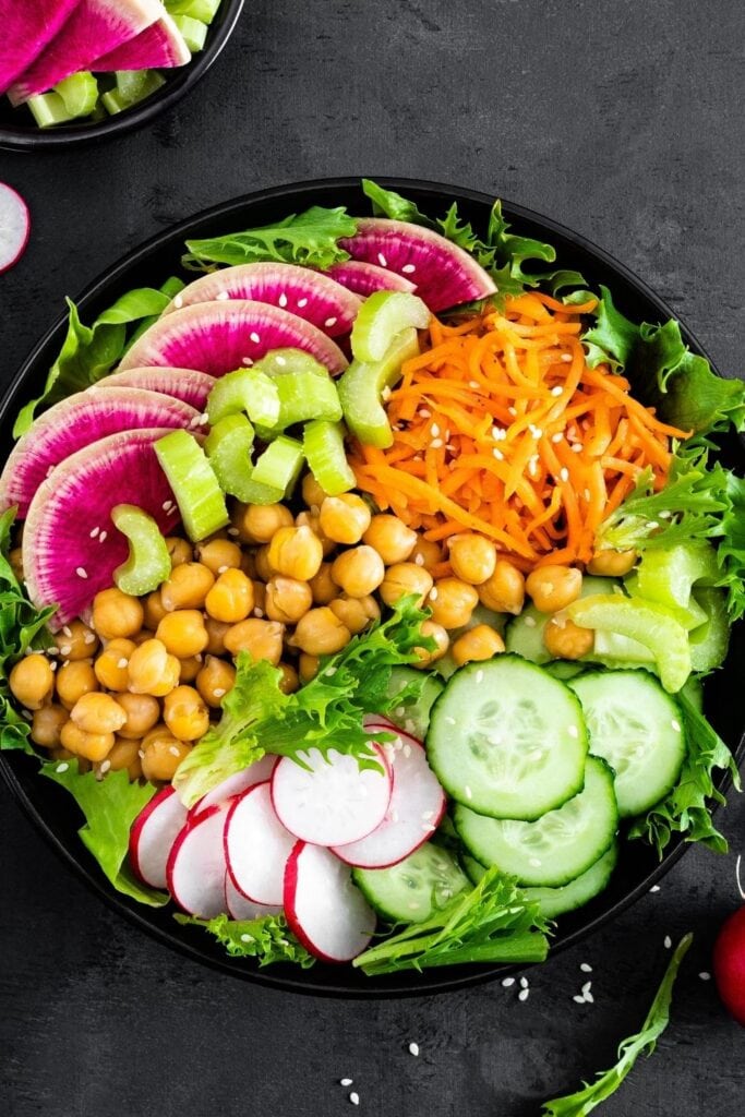 Healthy Buddha Bowl Salad with Chickpeas, Carrots, Cucumber and Watermelon Radish