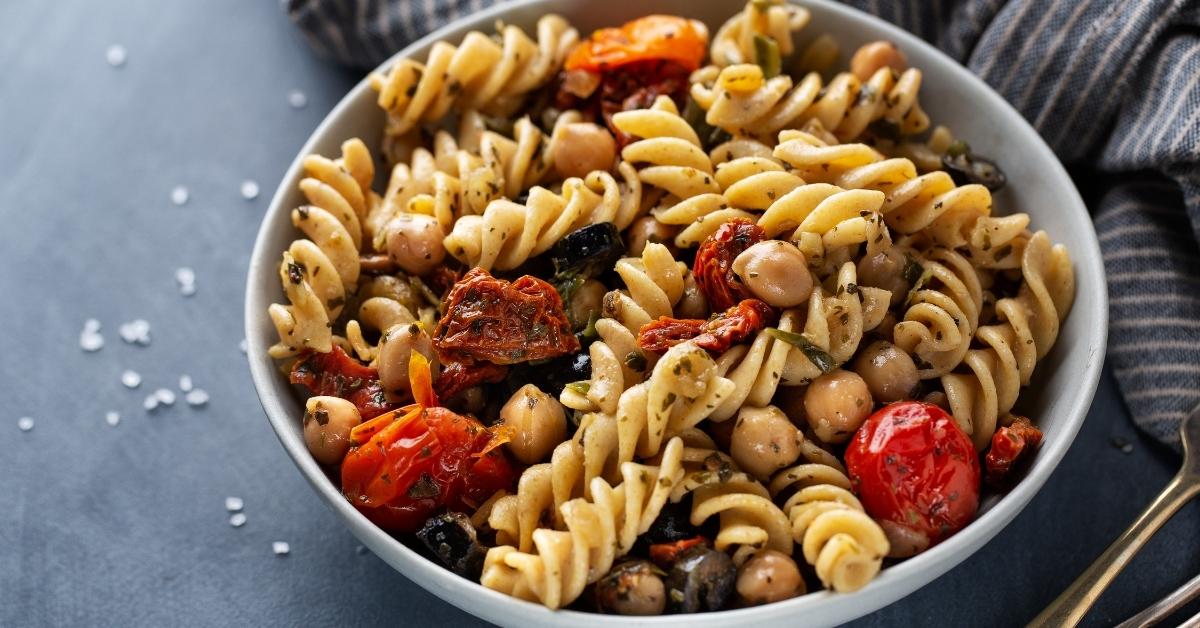 Homemade Chickpea Pasta with Sun-Dried Tomatoes and Black Olives in a Bowl