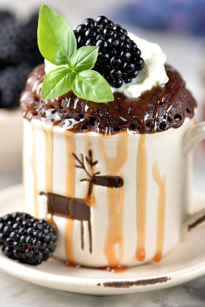 Homemade Chocolate Mug Cake with Blackberries and Syrup