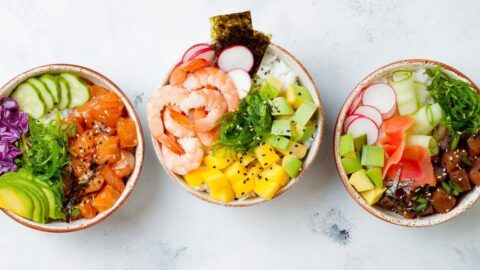 Homemade Hawaiian Poke Bowls: Salmon, Tuna and Shrimp with Mango, Avocados, Seaweeds and Cucumber