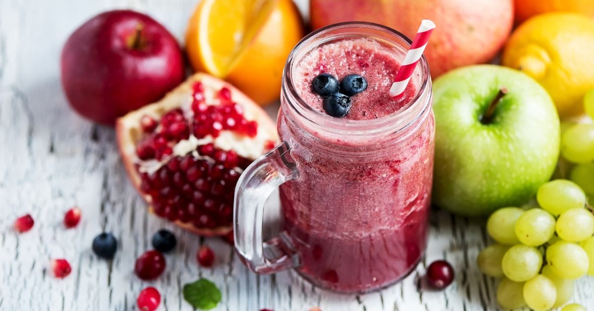 Homemade Refreshing Berry Smoothie with Apple, Pomegranate, Grapes and Oranges