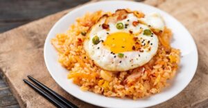 Kimchi Fried Rice with Egg in a White Plate
