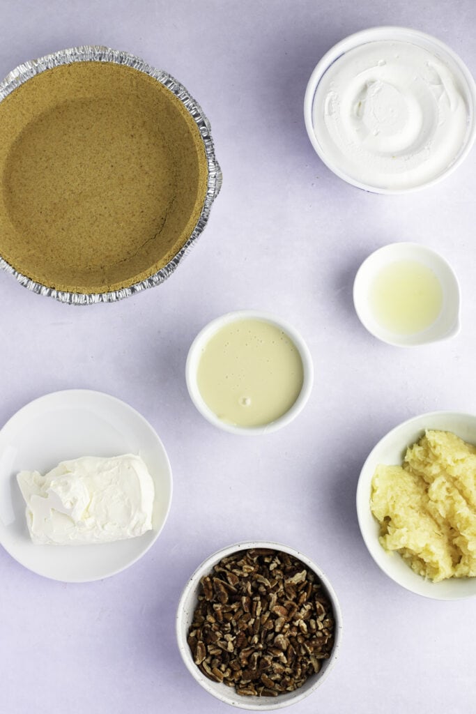 Millionaire Pie Ingredients: Cream Cheese, Condensed Milk, Lemon Juice, Crushed Pineapple and Chopped Pecans