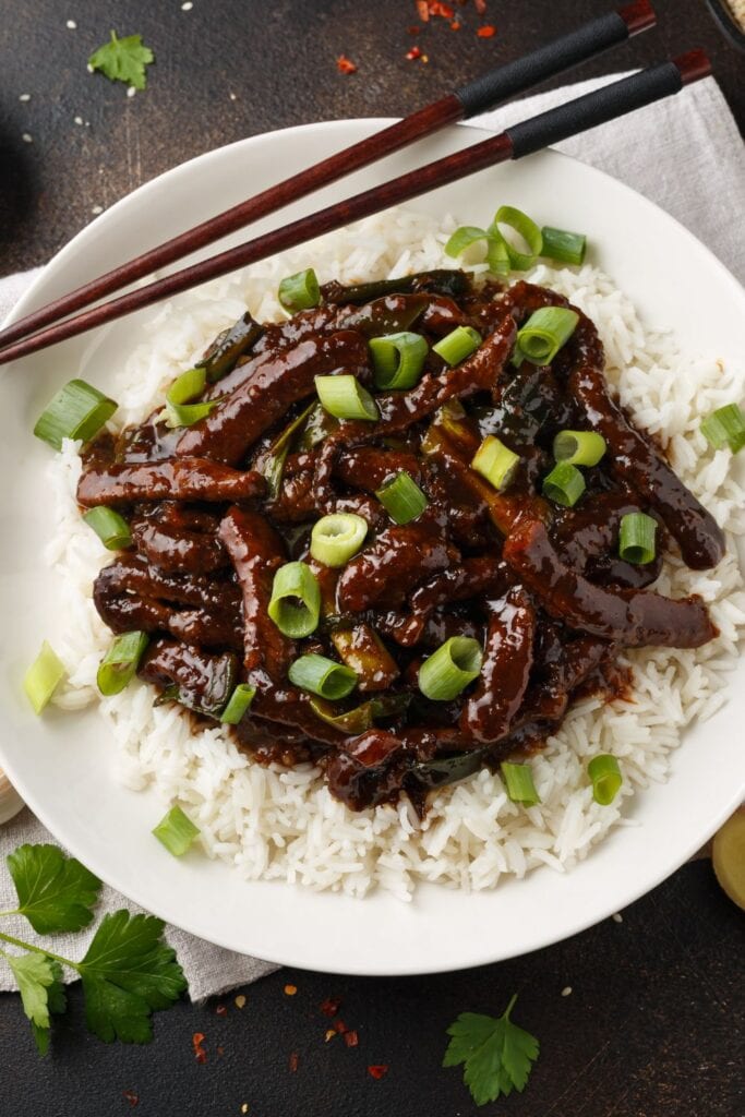 17 Asian Beef Mains (Quick and Easy). Shown in picture: Mongolian Beef with Rice and Green Onions
