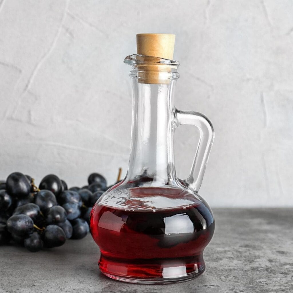 Red Wine Vinegar in a Jug with Fresh Grapes