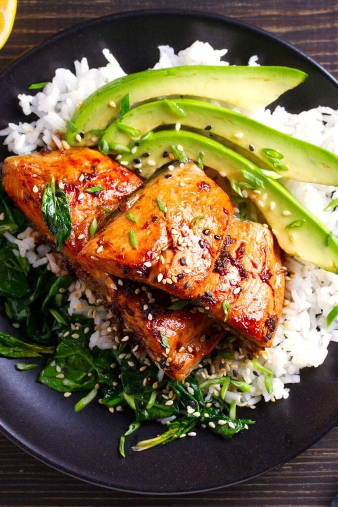 Salmon and rice with green vegetables and avocados