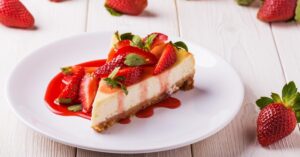Slice of Sweet Homemade Cheesecake with Fresh Strawberries