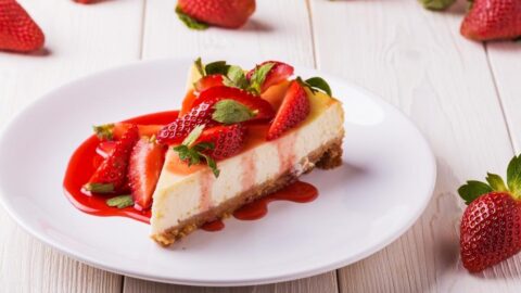 Slice of Sweet Homemade Cheesecake with Fresh Strawberries