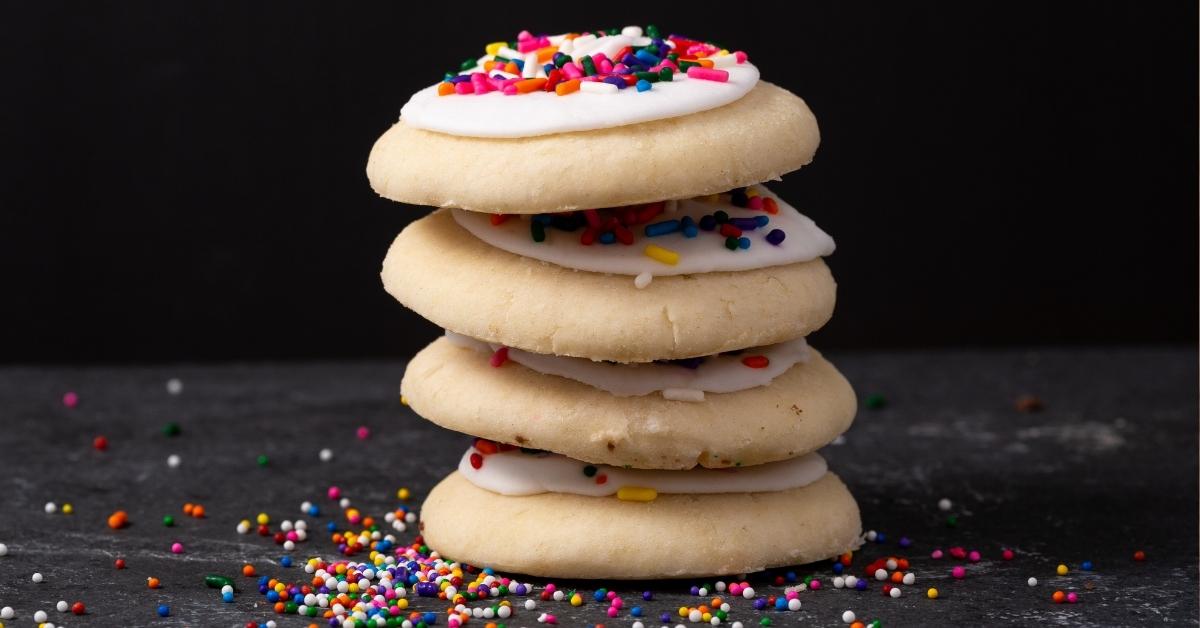 Stacked Homemade Sweet Cookies with Vanilla Icing and Candy Sprinkles