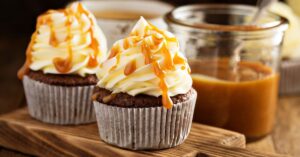 Sweet Homemade Butterscotch Cupcake with Caramel Syrup in a Wooden Cutting Board