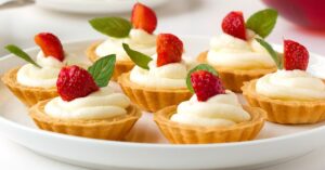 Sweet Homemade Mini Tarts with Fresh Strawberries and Cream Frosting