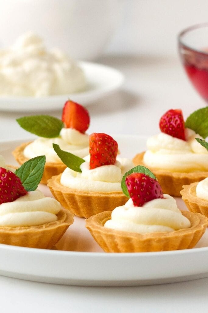 23 Easy Mini Tart Recipes for a Delectable Dessert: Sweet Mini Tarts with Cream Frosting and Strawberries