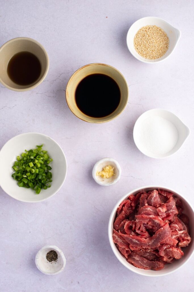 Beef Bulgogi Ingredients - Steak, Soy Sauce, Sugar, Green Onions, Garlic, Sesame Seeds and Pepper
