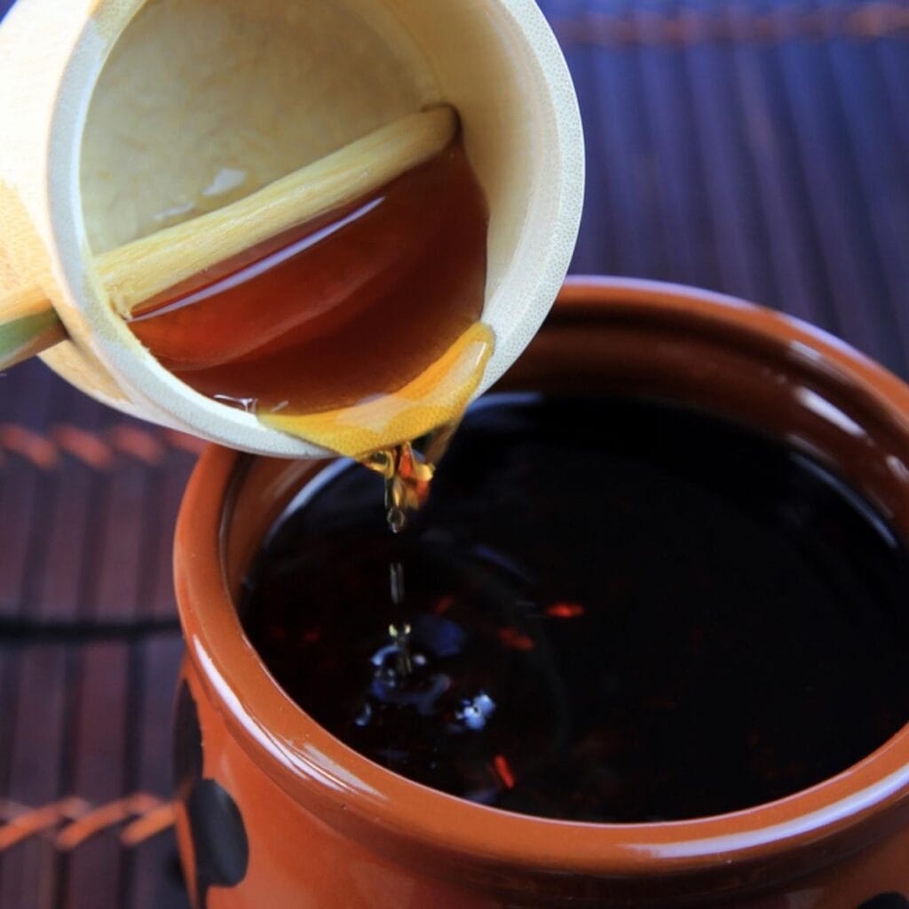 Black Vinegar Poured in a Brown Pot