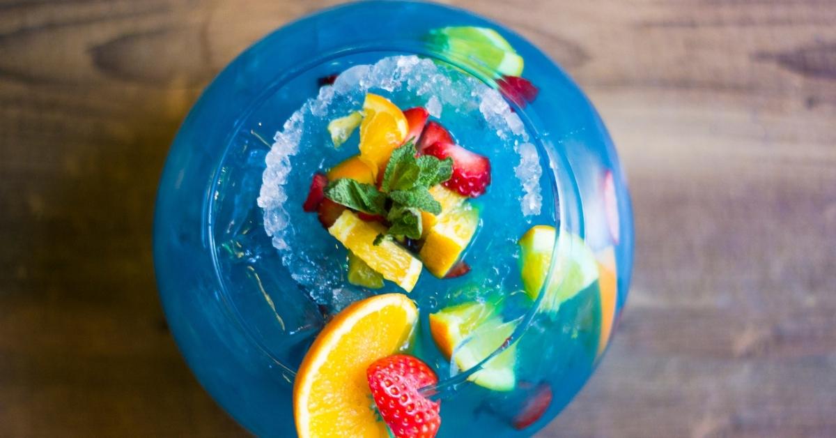 Boozy Fish Bowl Cocktail with Blue Curacao and Fresh Fruits