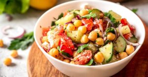 Bowl of Homemade Chickpea Salad with Tomatoes, Onions, Cucumber and Feta