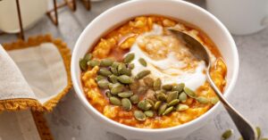Bowl of Homemade Pumpkin Oatmeal Porridge with Seeds and Yogurt